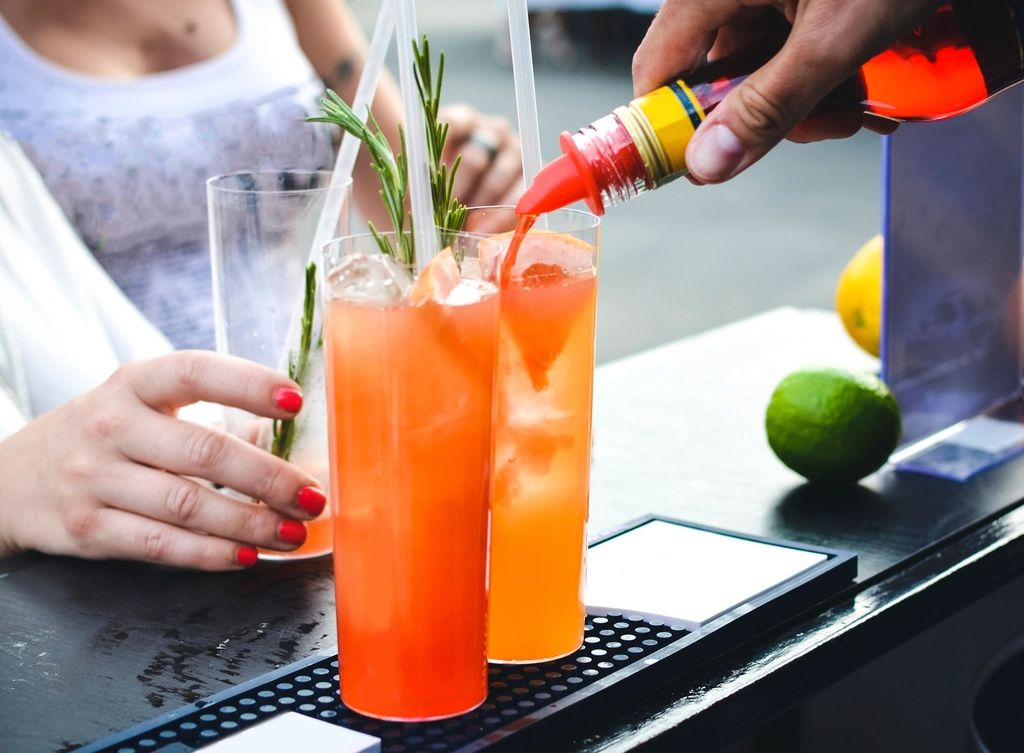 A cocktail being finished at the bar