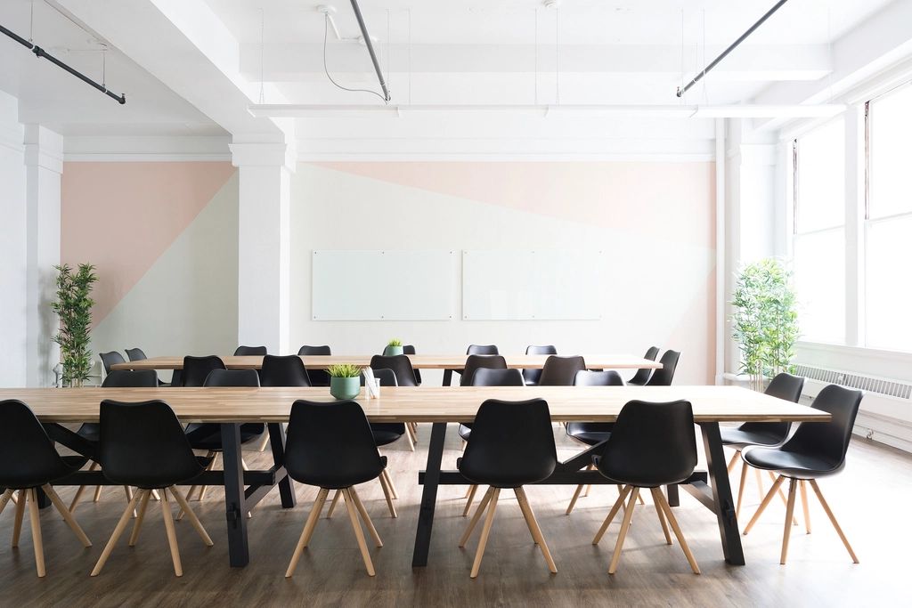 A meeting room with a long table and chairs