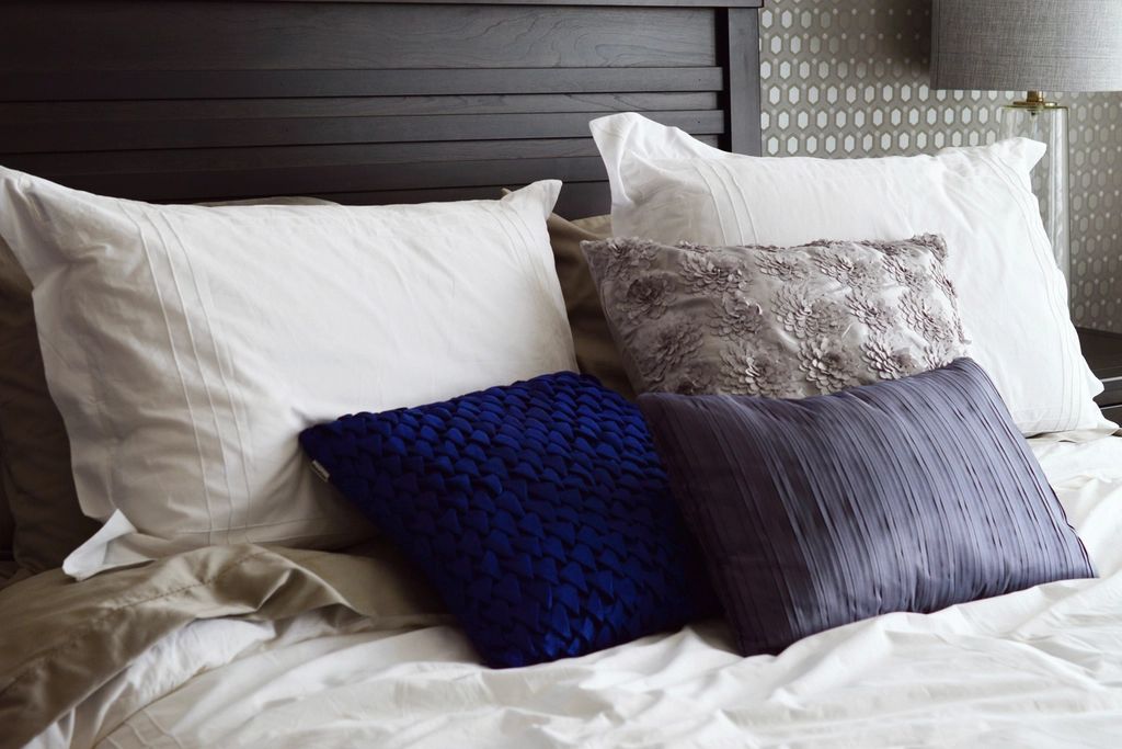 A guest room with a large bed and soft lighting